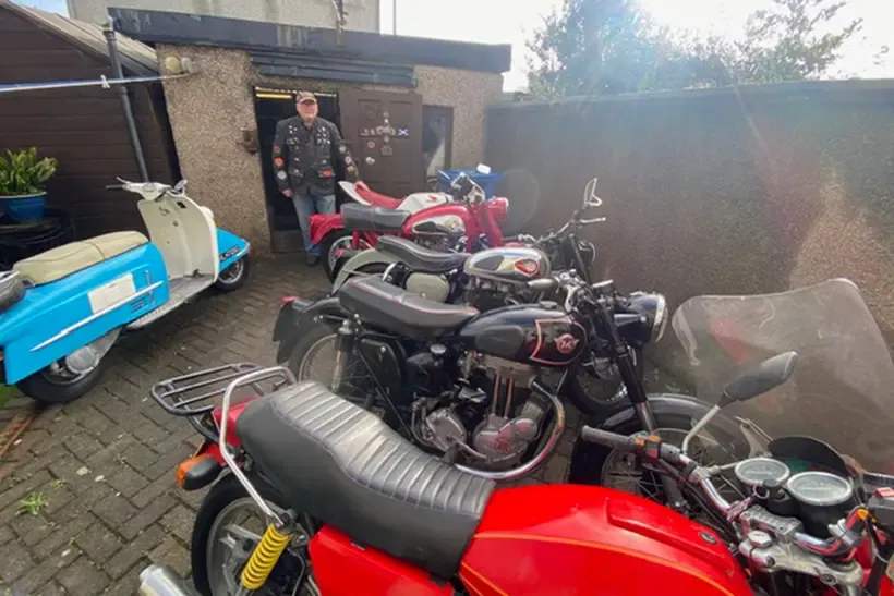 Peter with all his classic bikes and Heinkle 175 in blue on the left hand side