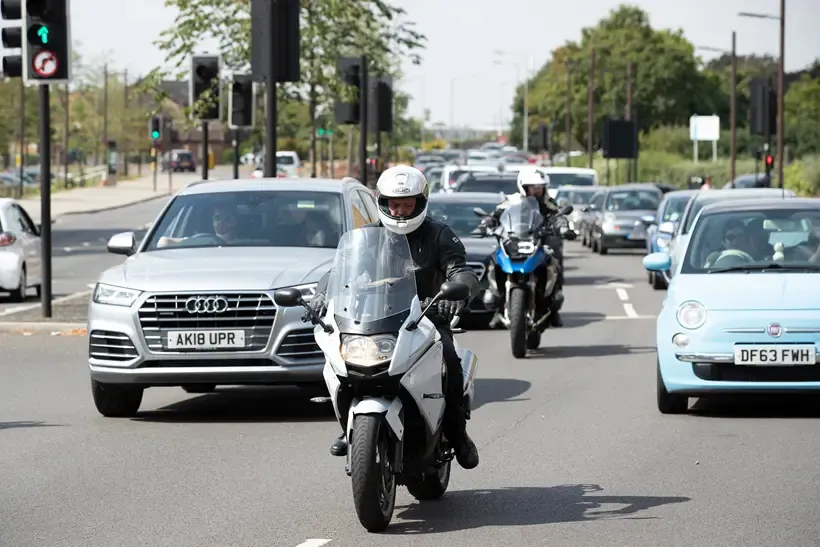 Motorcycles filtering towards the camera