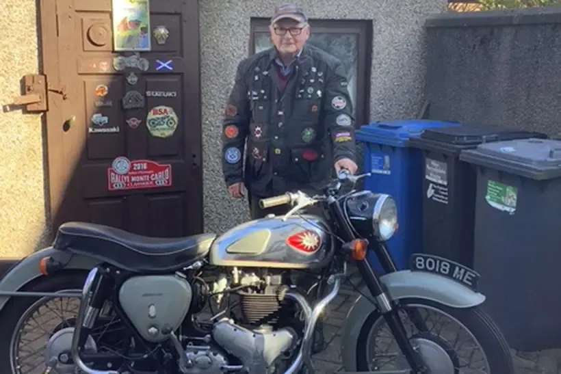 Peter in his well patched bike jacket stood behind his 1960 BSA gold flash 