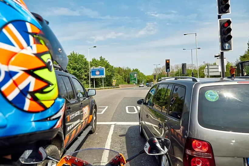 Motorcycle filtering through traffic at lights
