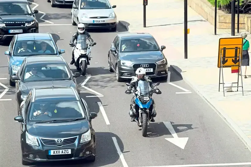 Motorcycles move through heavy traffic
